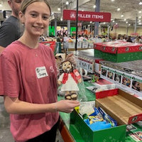 Workers at the Operation Christmas Child Processing Center in Boone, NC. are packing The Shoebox Jesus Doll into shoeboxes to be distributed to children around the world.