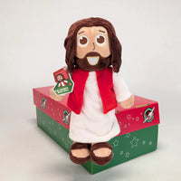 The Shoebox Jesus Doll sits on an Operation Christmas Child shoebox. A perfect WOW gift for shoebox donations.